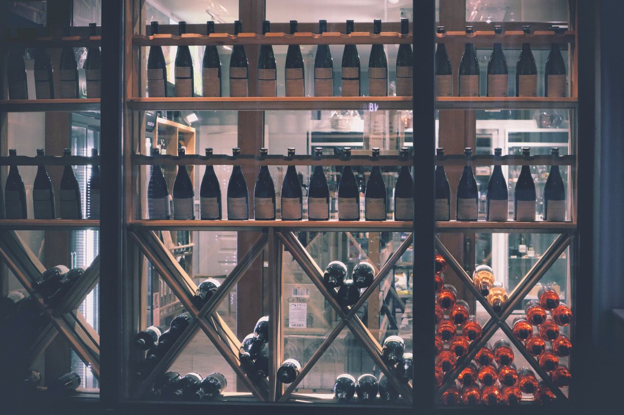 The Art of Drawing Readers In: Your attractive post title goes here A beautifully arranged wine display in a market setting, featuring diverse bottles.